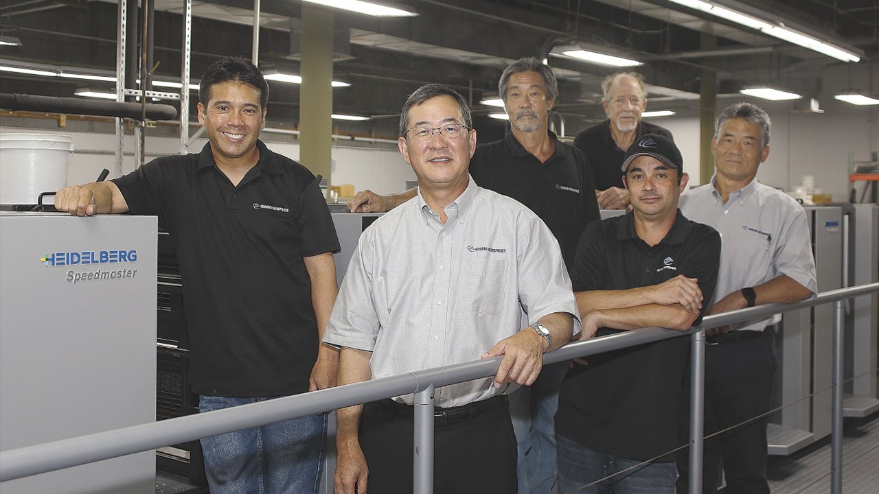 L-R front row: Jason Fujikawa, press supervisor; Sanford Morioka, president; Gerald Gakiya, pressman; Duane Kong, vice president of sales; L-R back row: Alex Upton, vice president of operations; Ben Hauger, pressman